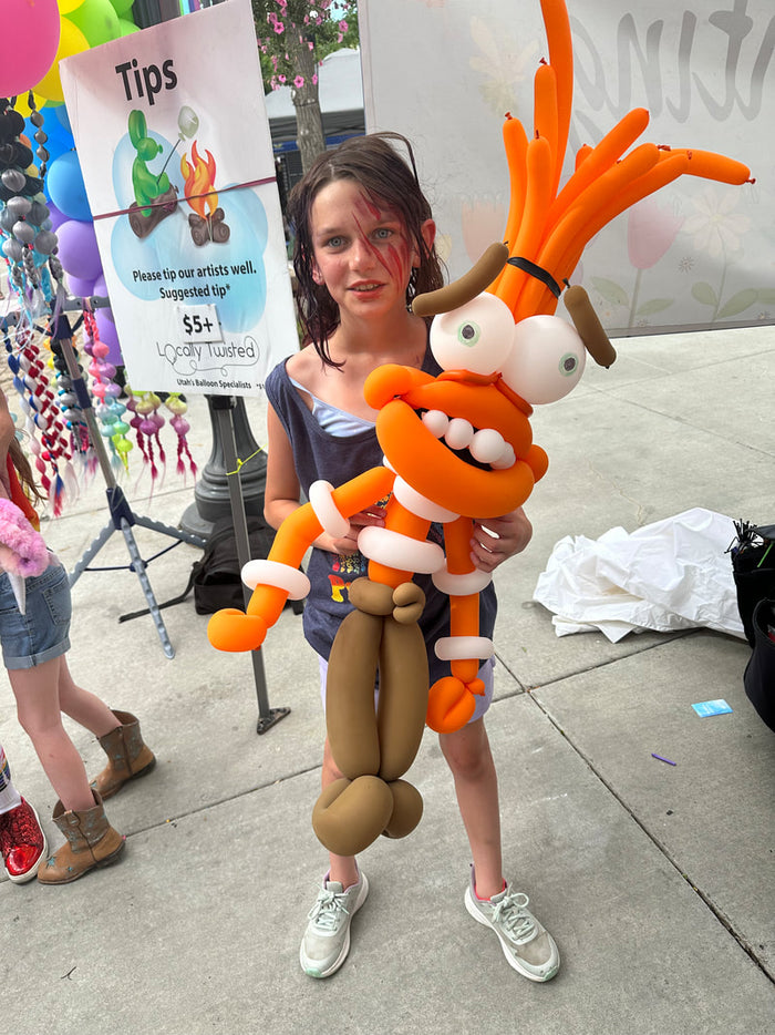 Detailed balloon twisting character held for a party photo