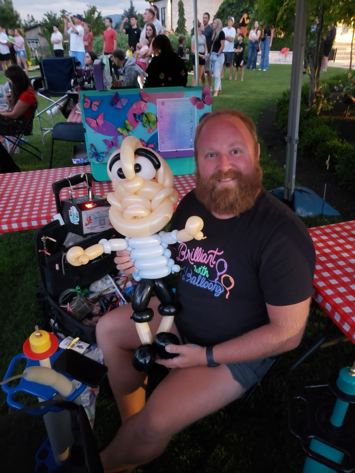 Balloon artist twisting a colorful event design